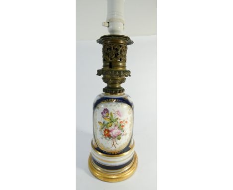 An early 20th century porcelain lamp base with later conversion to electricity signed L Hadret to collar, 15" high including 