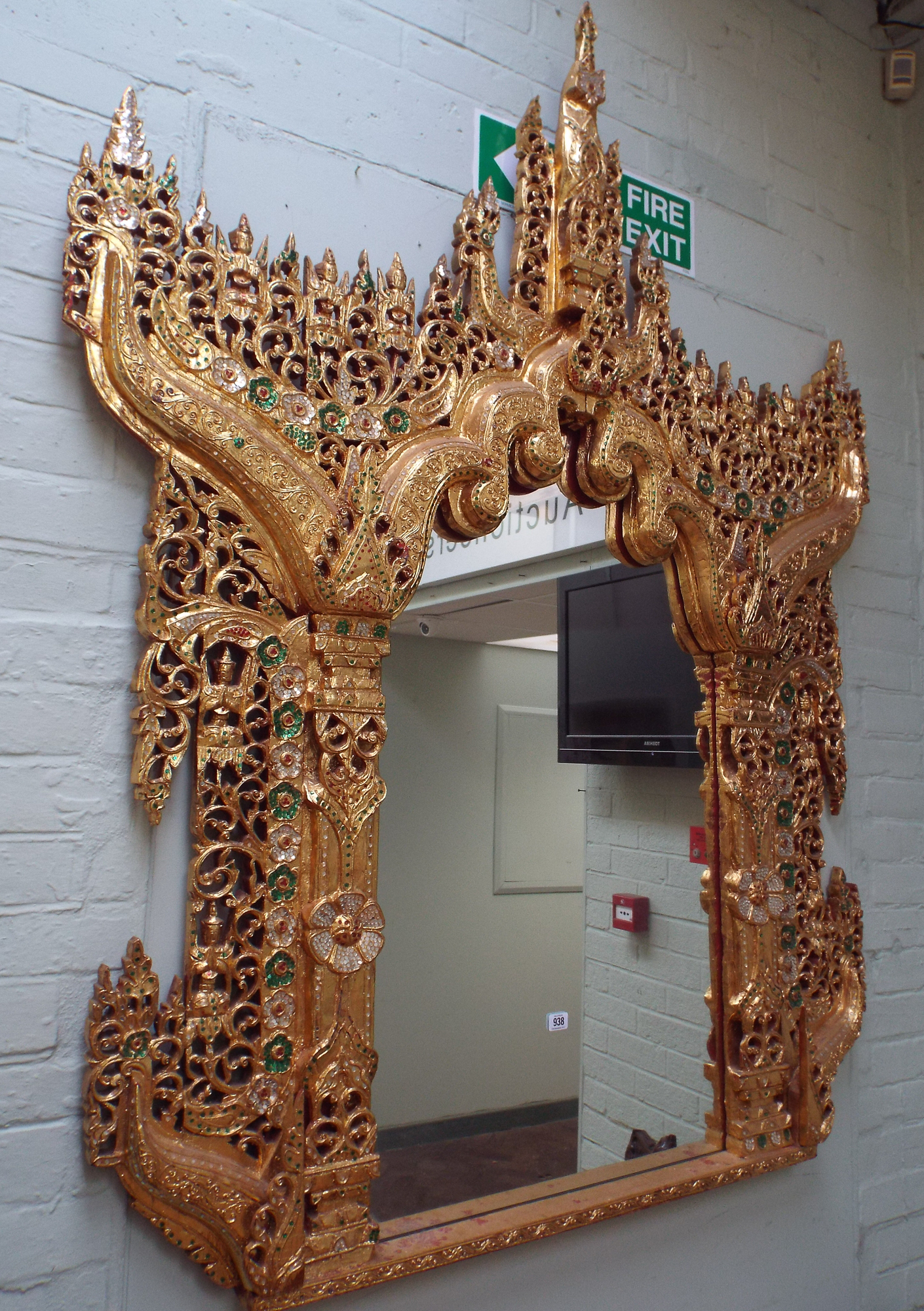 A very large Thai wall mirror in a decorative gold leaf & mirrored and
