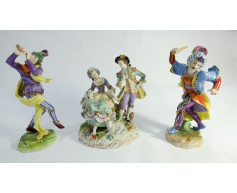 Two Dresden porcelain figurines of court jesters and a pastoral group of shepherd and shepherdess with lamb at feet. Blue pri