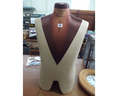 A torso mannequin no stand or arms 