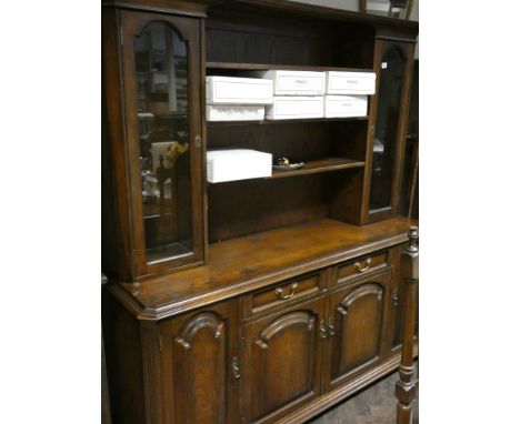 A 5'6 reproduction oak dresser with shelf and cabinet back on a sideboard style base matching the previous lot 