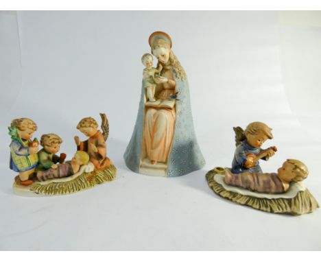 Three Hummel figurines of Virgin Mary and infant Jesus and two other nativity style scenes