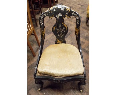 A Victorian black lacquered gilt and mother of pearl decorated occasional chair with cane panelled seat standing on cabriole 