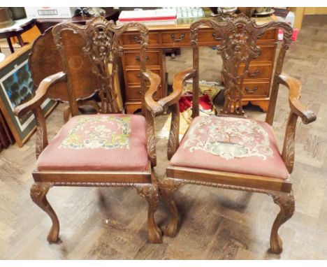 A pair of Chippendale style mahogany elbow chairs on cabriole style legs with tapestry upholstered seats 