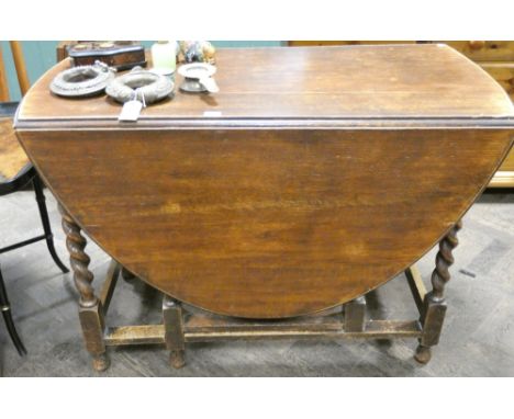 A 3'6 oval oak gate leg dining table on barley twist legs 