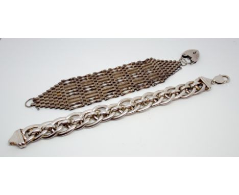 A large silver gate bracelet with padlock fastening and a wide silver plated link bracelet