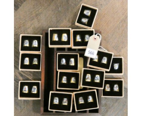 A collection of Hummel School children collectors thimbles 26 in the lot together with a thimble display rack 