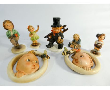 Collection of seven Hummel figurines of children and wall plaques of babes with bees. Three with boxes  