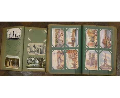 Two old postcard albums containing approximately 350 postcards featuring mostly topographical views to include many scenes fr