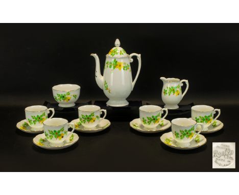 Hand Painted Coffee Set by Roslyn in white ground with delicate yellow and green floral design. Comprises: six cups, six sauc
