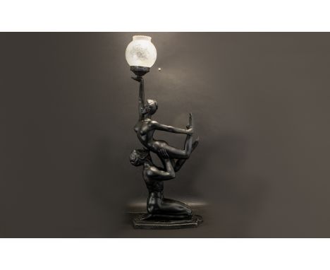Large Decorative Art Deco Style Lamp of a male and female in a balletic pose, the female holding aloft the lamp.  Black colou