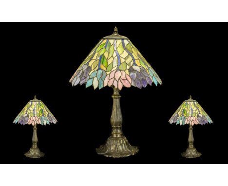 Large Tiffany Style Table Lamp on decorative floriate metal base, with floral relief to shade in colours of pink, green, blue