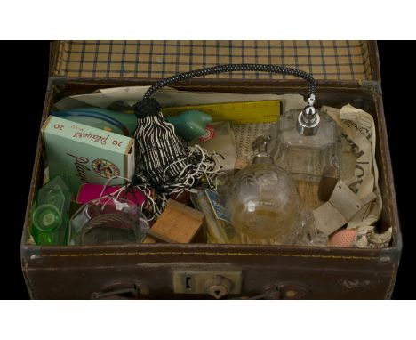 A Small Vintage Suitcase containing various assorted collectables. To include perfume bottles, atomisers, ceramics, Avon bott