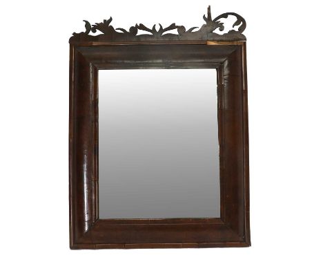 A William &amp; Mary Walnut Cushion-Framed Wall Mirror, the later plain mirror plate within a moulded frame surmounted by a p