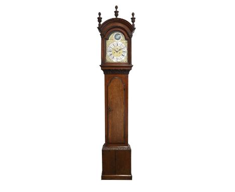 An Oak Eight Day Longcase Clock, arch pediment, arch crossbanded trunk door, carved borders, 12-inch arch brass dial with a s