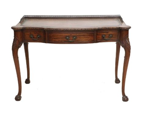 A Late 19th/Early 20th Century Carved Mahogany Writing Table, by Waring &amp; Gillow Ltd, the three-quarter pierced brass gal