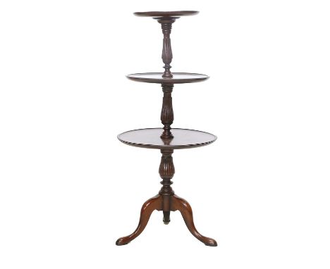 A George III-Style Mahogany Three-Tier Dumb Waiter, 20th century, bearing a Gillow stamp, of dished circular form with balust