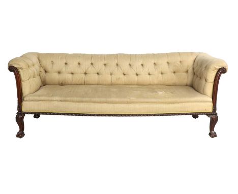 A Victorian Carved Mahogany Three-Seater Chippendale-Style Sofa, late 19th century, covered in worn yellow buttoned linen, wi