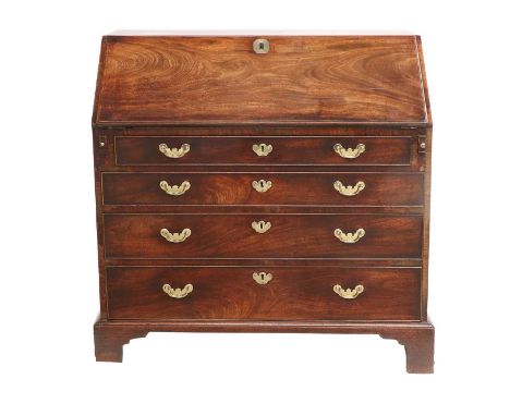 A George III Mahogany Bureau, circa 1760, the fall front with engraved brass escutcheon enclosing a later gilt tooled leather