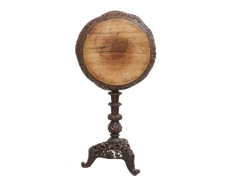 A Late 19th/Early 20th Century Anglo-Indian Carved Bombay Wood Tripod Table, the circular top above a foliate border pivoting