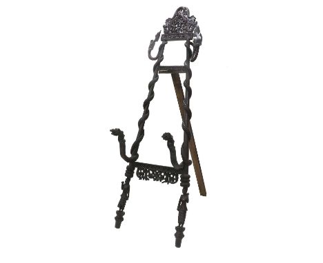 A Burmese Carved Teak or Hardwood Snake-Form Easel, early 20th century, foliate carved with mythological beasts, the supports