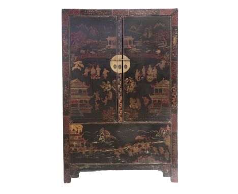 A Chinese Ebonised and Parcel Gilt Wedding Cabinet, late 19th/early 20th century, the two cupboard doors painted with figures