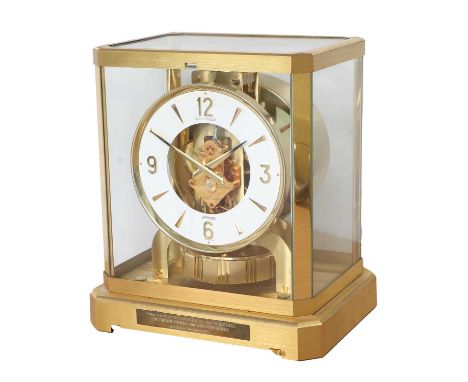 A Brass Atmos Clock, signed Jaeger LeCoultre, 20th Century, case with glass panels, front of the base with applied presentati