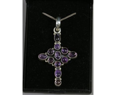 A silver amethyst set cross pendant on chain.