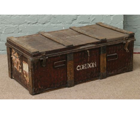 A mid C19th Japanned tin travelling trunk, wood bound and stencilled Gordon.