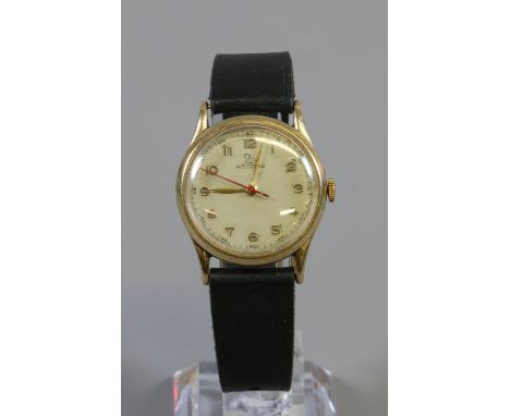 A vintage Record 9ct gold wristwatch manual wind, white enamel face with swan logo and black leather strap.