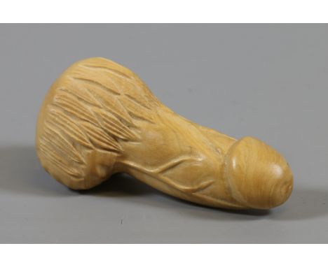 A carved hardwood erotic Netsuke formed as a phallus.