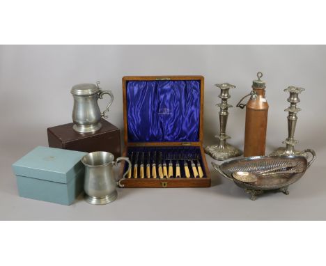 A collection of metalwares including a pair of silver plated candlesticks two baluster tankards and a copper flask 