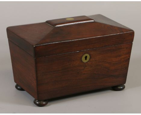 A Regency rosewood two compartment tea caddy raised on squat bun feet. 