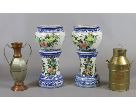 Two ceramic jardinieres on stands decorated with flowers and leaves along with a ornamental miniature brass milk churn and tw