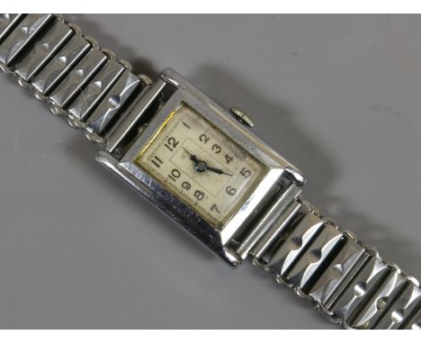 A gentleman's Art Deco manual bracelet watch of tank shape. The rectangular dial signed M. P. and with Arabic numeral markers