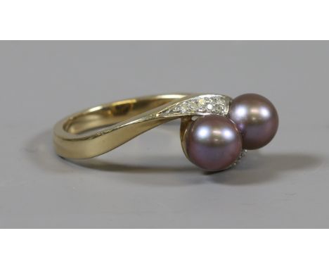 A 9ct gold diamond and coloured cultured pearl crossover ring, size P.