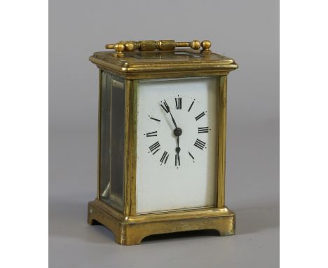 A brass cased carriage clock with enamel dial and Roman numeral markers. Sold with key, AF.