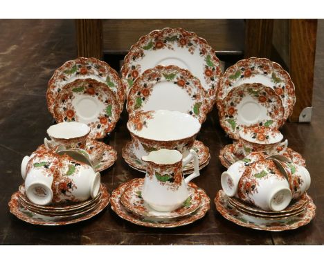 An Edwardian china tea service decorated with flowers marked Wellington china by Longton England, 36 pieces.