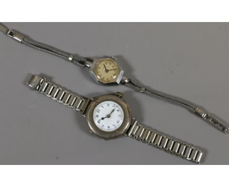 A ladies vintage Peerex stainless steel manual bracelet watch and a silver cased manual wristwatch on white metal bracelet.