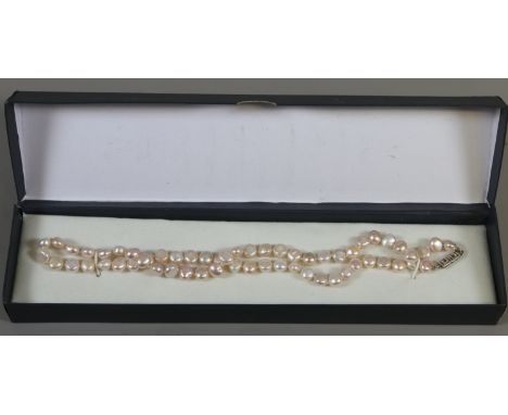 A cultured pearl necklace with silver Greek key box clasp.
