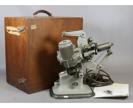 A vintage G.B. Bell and Howell model 613 16mm Cine projector in carry case with printed operation instruction.