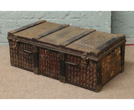 A mid C19th Japanned tin travelling trunk, wood bound and stencilled Gordon.