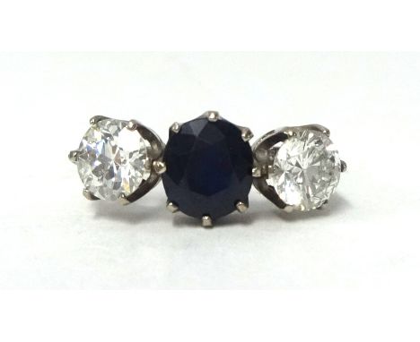 A fine antique three stone ring, set with a central sapphire and two round cut diamonds, each approx 1.00 ct, size K.