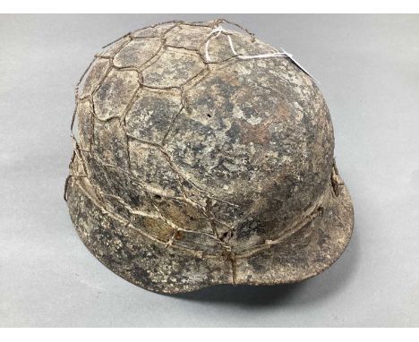 WWII German Army M40/M42 Combat Helmet, with remnants of attached chicken wire half basket, shell only, semi relic condition.