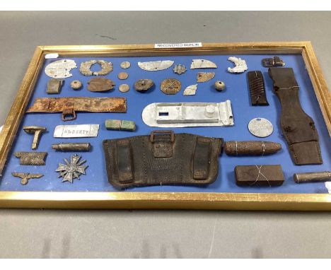 WWII German Third Reich Relics, including remnants of identification discs, buttons, ammunition pouch, etc all presented in g