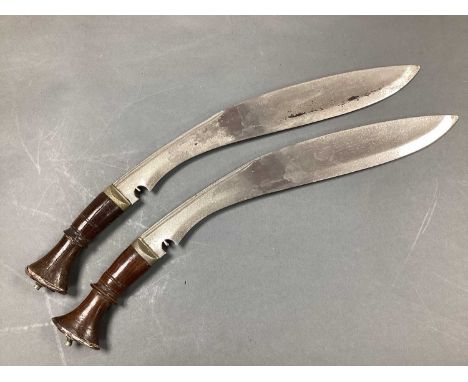 Two Kukri Knives, discolouration to blades and split to wood grip.