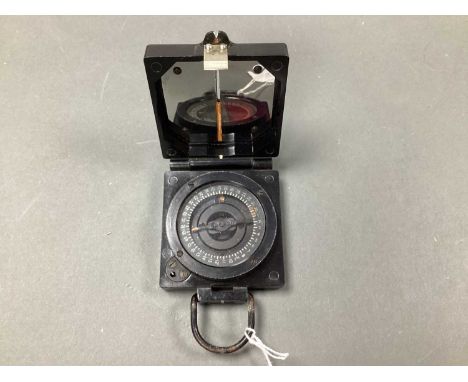 Military Magnetic Marching Compass, Mark 1, in black casing bearing military arrow.