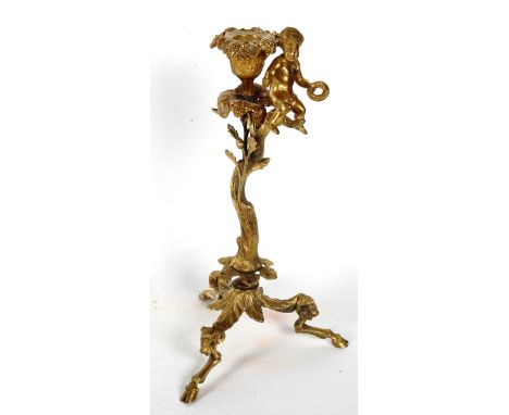 A 19th century gilt-brass putti and acorn candlestick, with ram's head and hoof feet, height 30cm 