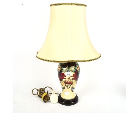 A Moorcroft cream ground table lamp, with tube-lined floral decoration, and shade, height overall 60cm 