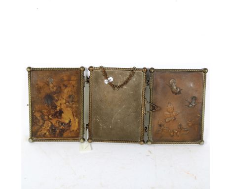 A Vintage brass-framed relief embossed folding triple mirror 